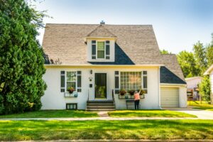 First-time buyers review home documents at a kitchen table beside a calculator and house keys