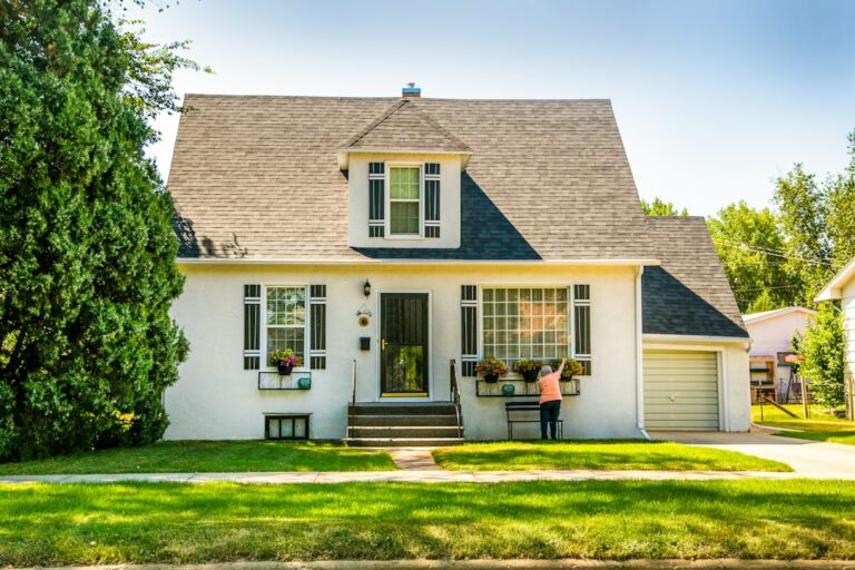 First-time buyers review home documents at a kitchen table beside a calculator and house keys